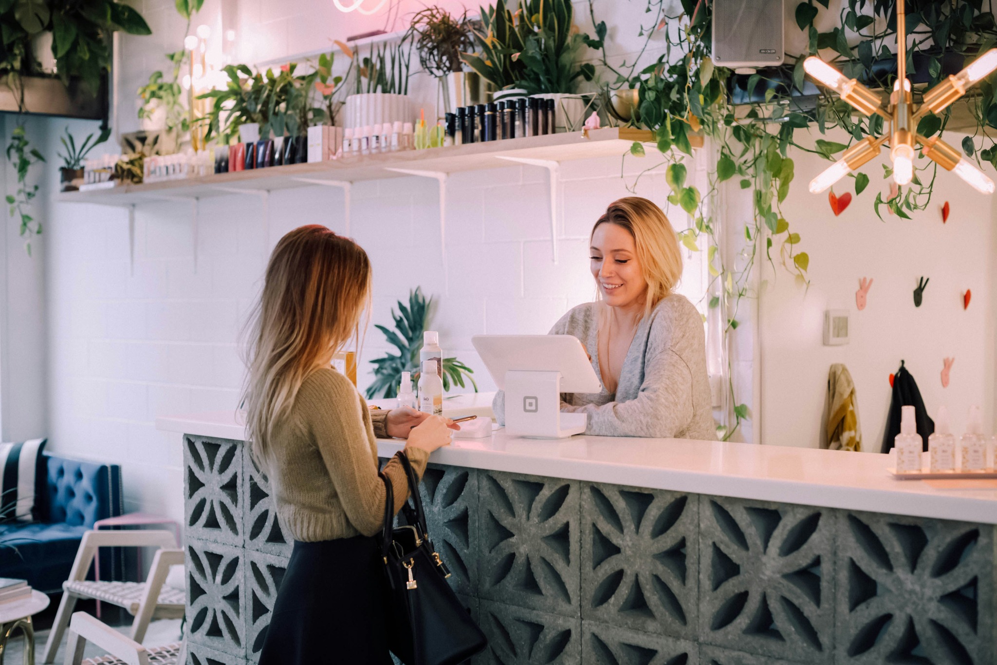 A customer speaking with a small business owner at the counter